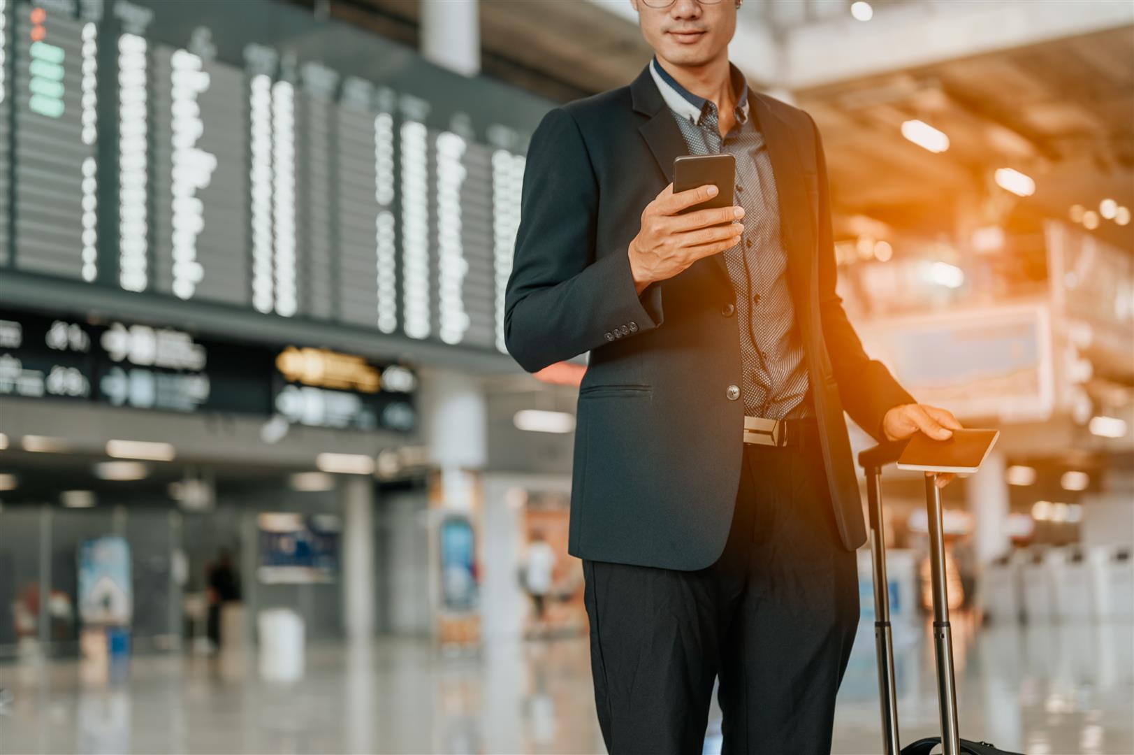 young-businessman-timetable-screen-board-using-smart-phone-flight-board.jpg